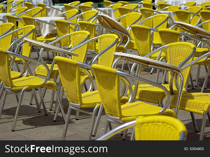 Yellow chairs in lines at the street. Yellow chairs in lines at the street