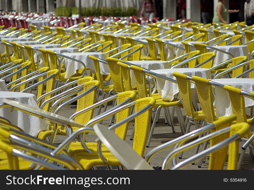 Yellow chairs in lines at the street