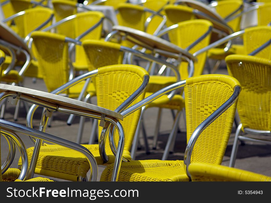 Yellow chairs in lines at the street