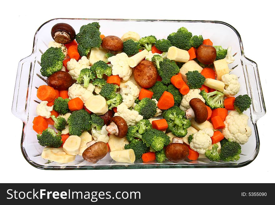 Baking dish with fresh chopped carrots, broccoli, cauliflower, parsnips and mushrooms. Baking dish with fresh chopped carrots, broccoli, cauliflower, parsnips and mushrooms.