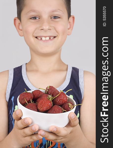 Boy holding plate with strawberry. Boy holding plate with strawberry