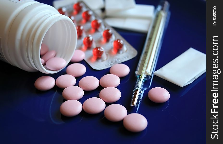 Tablets and pills on a dark blue background. Tablets and pills on a dark blue background.