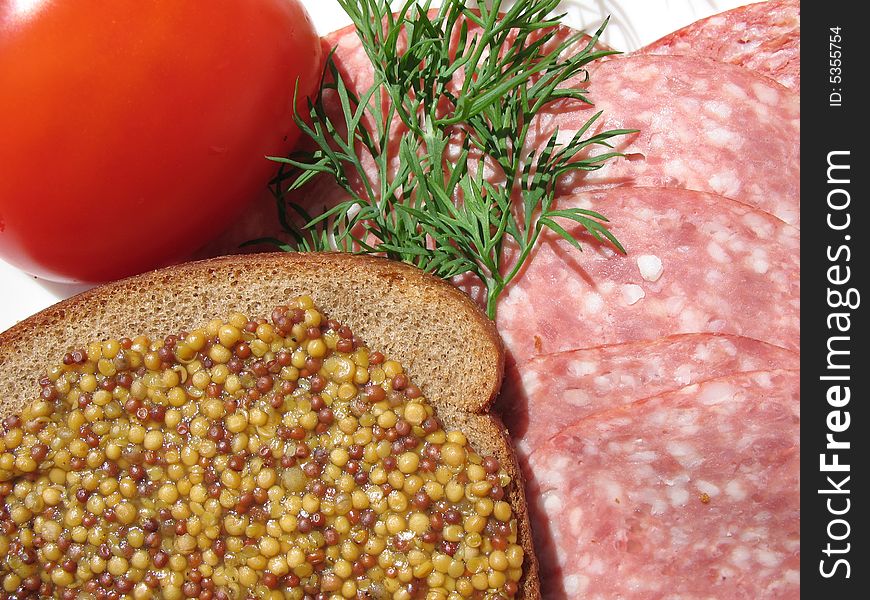 A food's still life with saveloy, tomato,  fennel and rye-bread with mustard