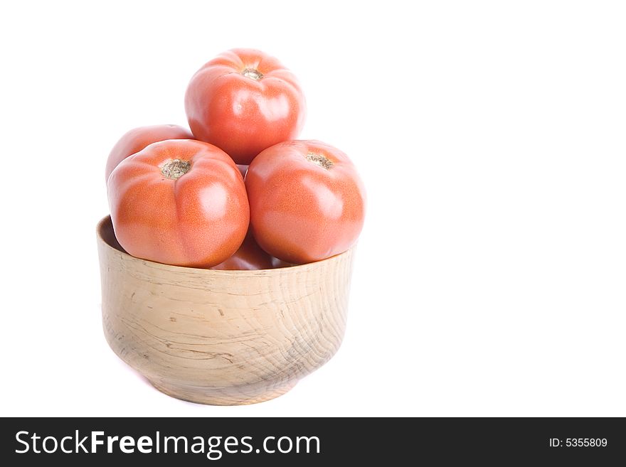 A bowl of fresh ripe red tomatoes on a white background. A bowl of fresh ripe red tomatoes on a white background