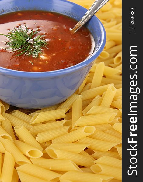 Red dressing in blue bowl with pasta. Red dressing in blue bowl with pasta