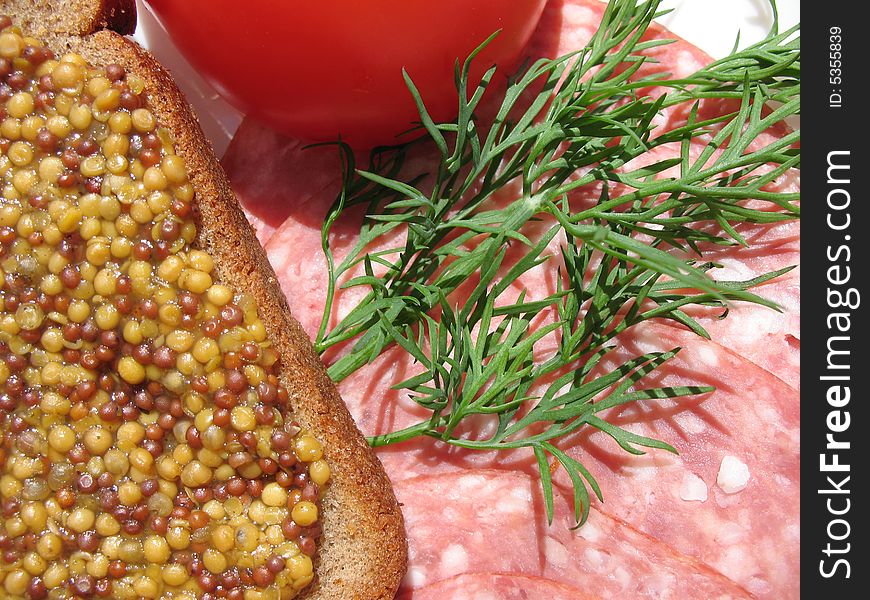 A food's still life with saveloy, tomato,  fennel and rye-bread with mustard