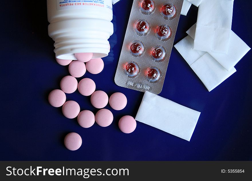 Tablets and pills on a dark blue background. Tablets and pills on a dark blue background.