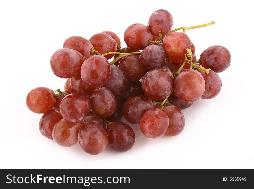 The bunch of ripe red grapes on the white background. The bunch of ripe red grapes on the white background