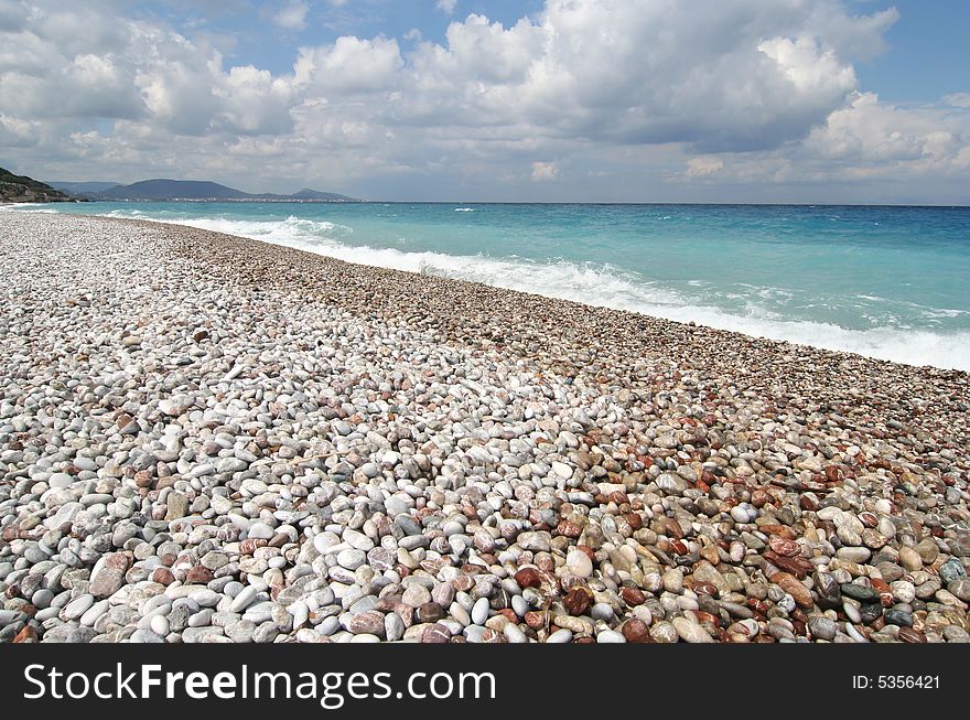 Pebble beach on the Mediterranean island of Rhodes, Greece. Pebble beach on the Mediterranean island of Rhodes, Greece