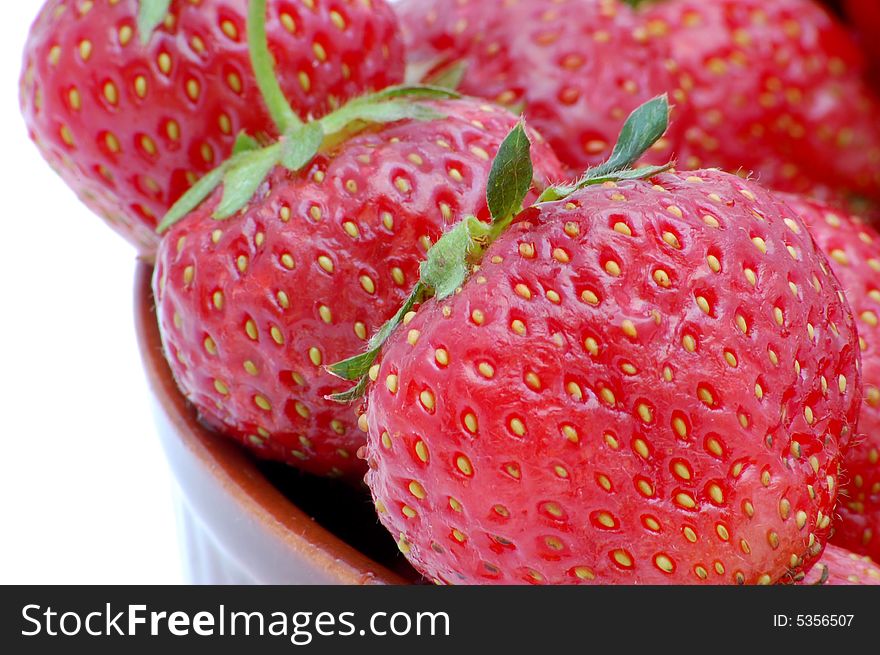 Strawberries in a bowl isolated on the white background