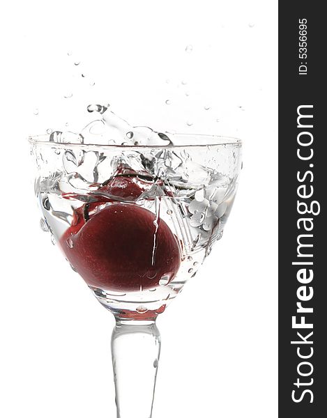 Cocktail with cherry falling into glass isolated on white. Cocktail with cherry falling into glass isolated on white