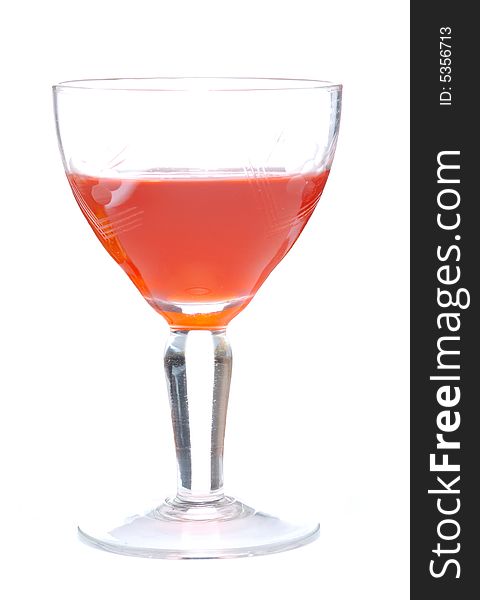 Orange drink into glass isolated over white background