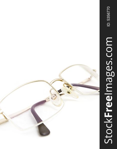 Glasses in a gold frame on a white background. Glasses in a gold frame on a white background
