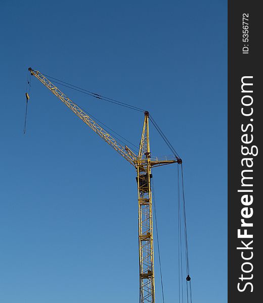 The elevating crane and blue sky