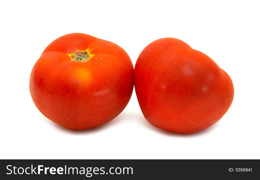 Two juicy tomato close-up over white background. Two juicy tomato close-up over white background