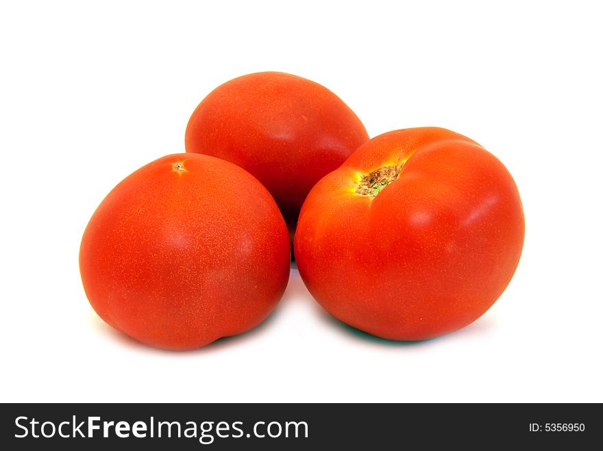 Three juicy tomatoes close-up over white background