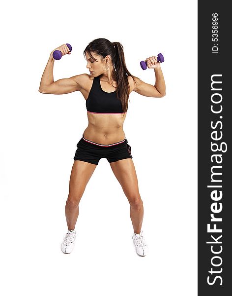 Beautiful brunette woman exercising with purple dumbbells