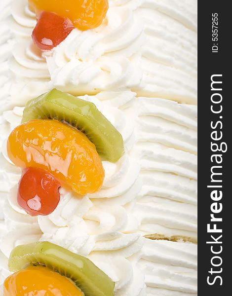 Close-up of whipped cream on the cake with a slices of fruits. Close-up of whipped cream on the cake with a slices of fruits