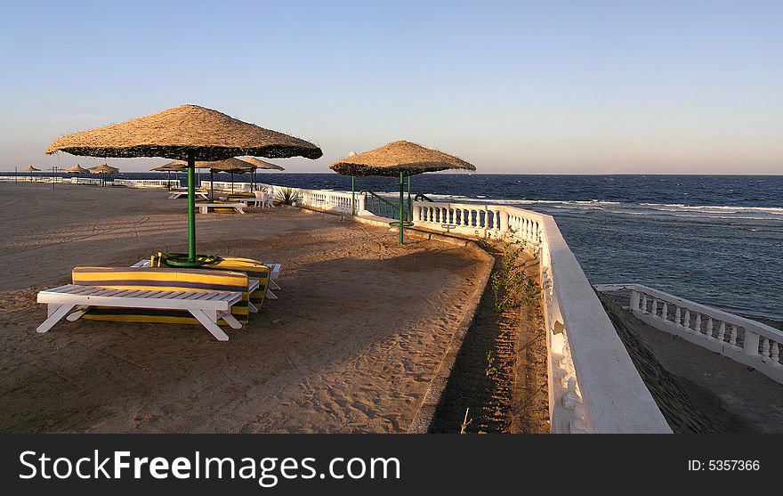 Exotic hotel beach with umbrellas