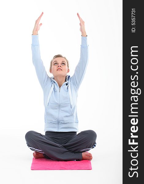 Young woman doing yoga on white