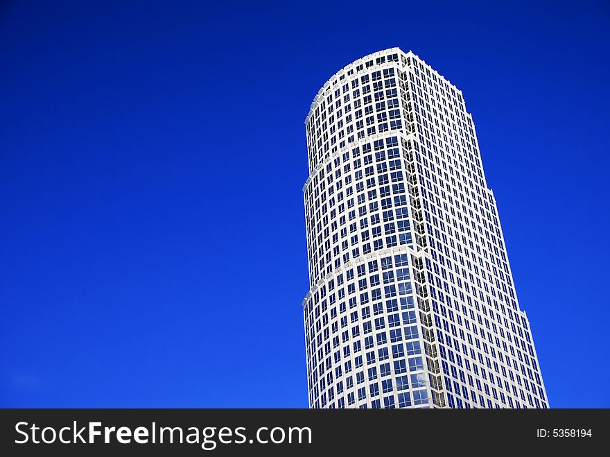 Lone Skyscraper On Against Blue Sky