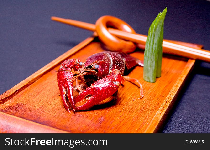 Seafood crawfish in a wooden plate.