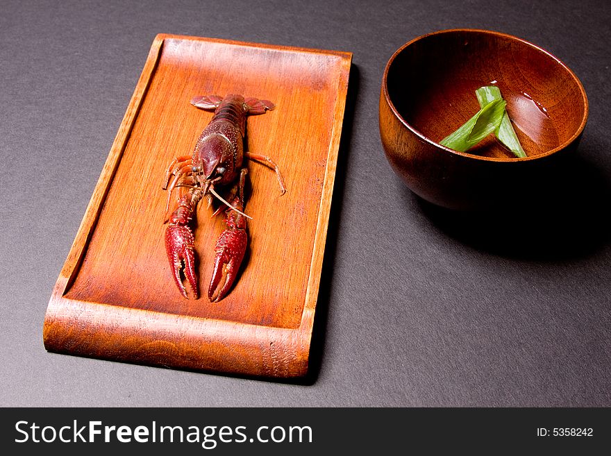 Seafood crawfish in a wooden plate. Seafood crawfish in a wooden plate.