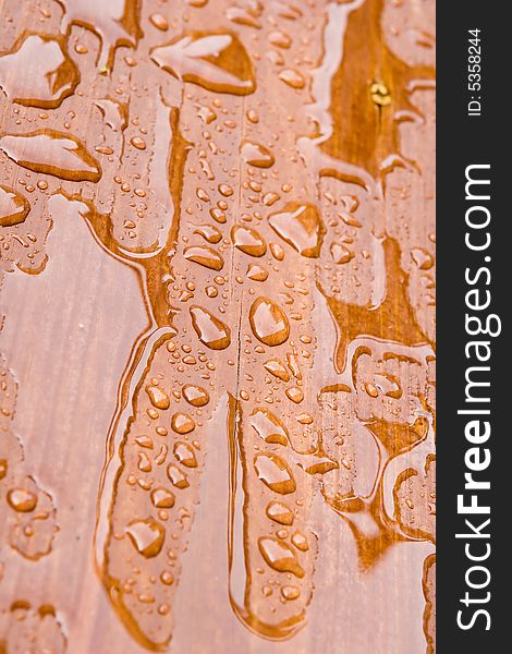 Rain Drops on a sealed wooden surface. Rain Drops on a sealed wooden surface