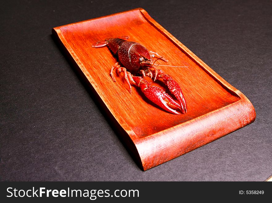 Seafood crawfish in a wooden plate.