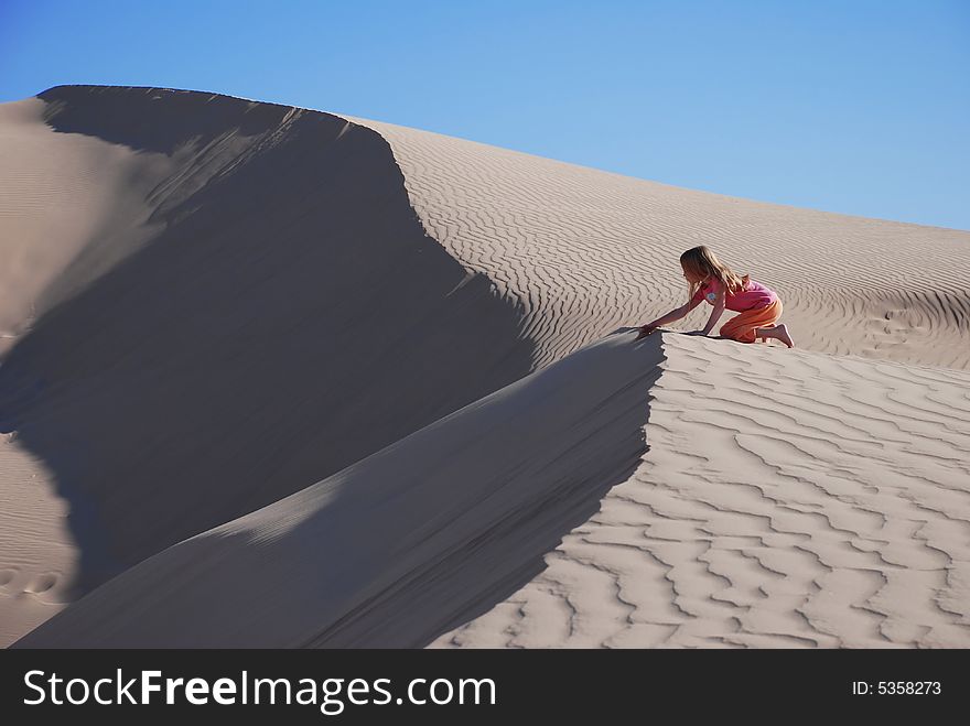 Young Girl Playing On Sand Dunes