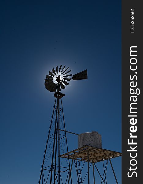 An image of a rural windmill on a blue sky. An image of a rural windmill on a blue sky