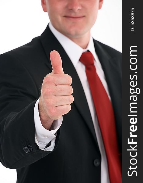 Portrait of a young attractive businessman giving the thumbs-up sign. Portrait of a young attractive businessman giving the thumbs-up sign.