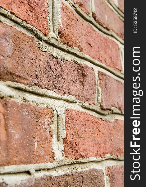 Aged red brick wall with distressed surface