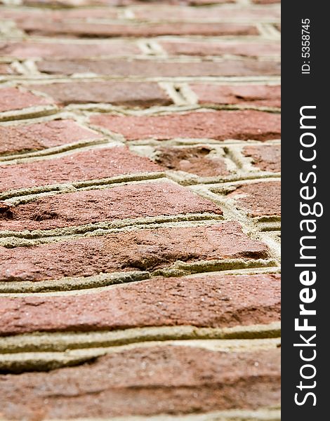 Aged red brick wall with distressed surface