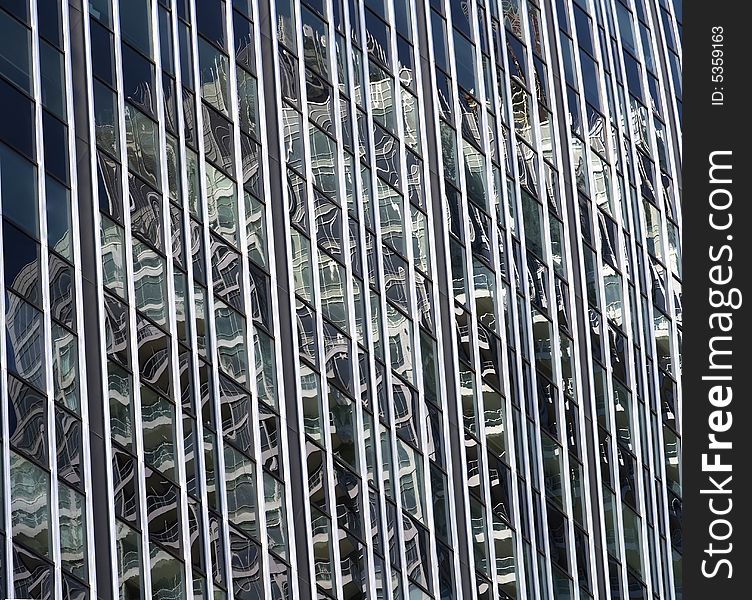 A bright sunny day creates wonderful reflections on the side of a highrise. A bright sunny day creates wonderful reflections on the side of a highrise.