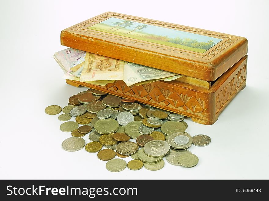 A wooden treasure chest with money