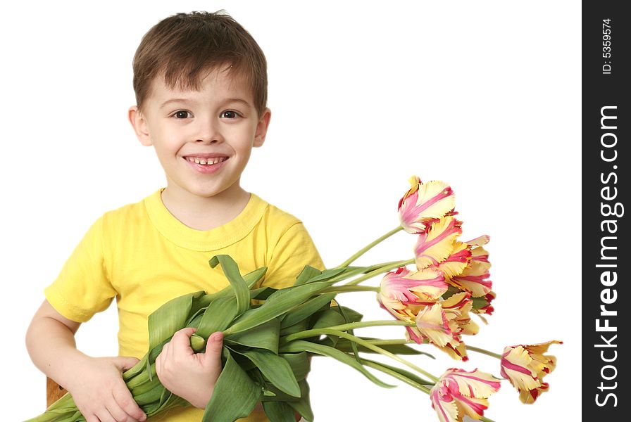 The happy boy with a bouquet of tulips