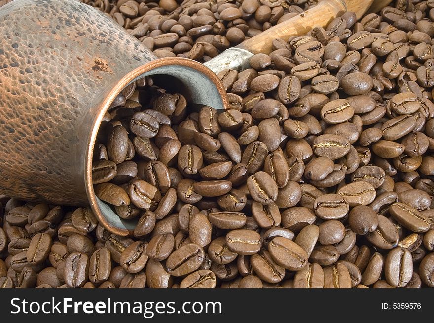 Turkish coffee pot on a background of coffee grains. Turkish coffee pot on a background of coffee grains.