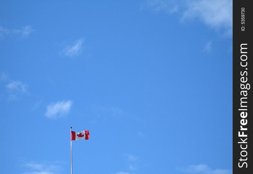 Canadian flag with blue sky