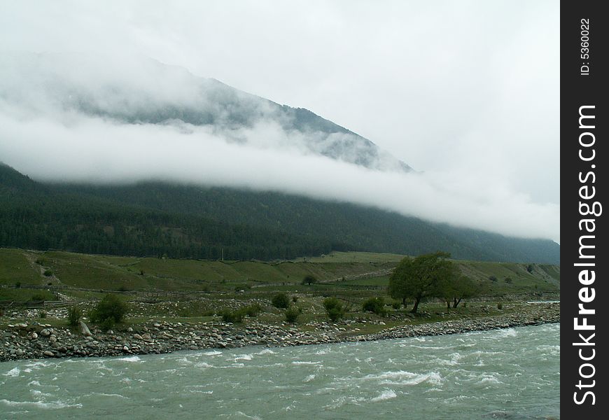 River, mountins on the background in the clouds. River, mountins on the background in the clouds