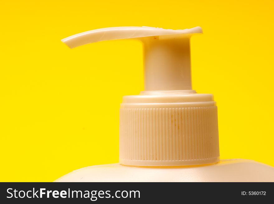 Cleaning supplies on yellow background