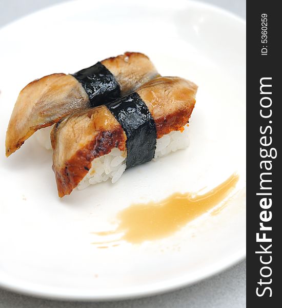 Unagi and rice sushi served on white plate. Unagi and rice sushi served on white plate