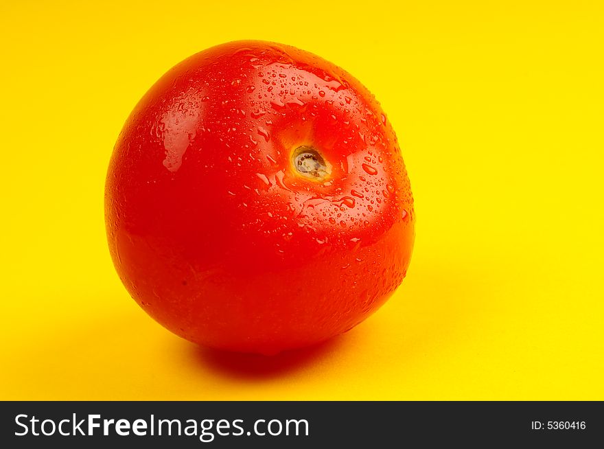 Tomato isolated on yellow background