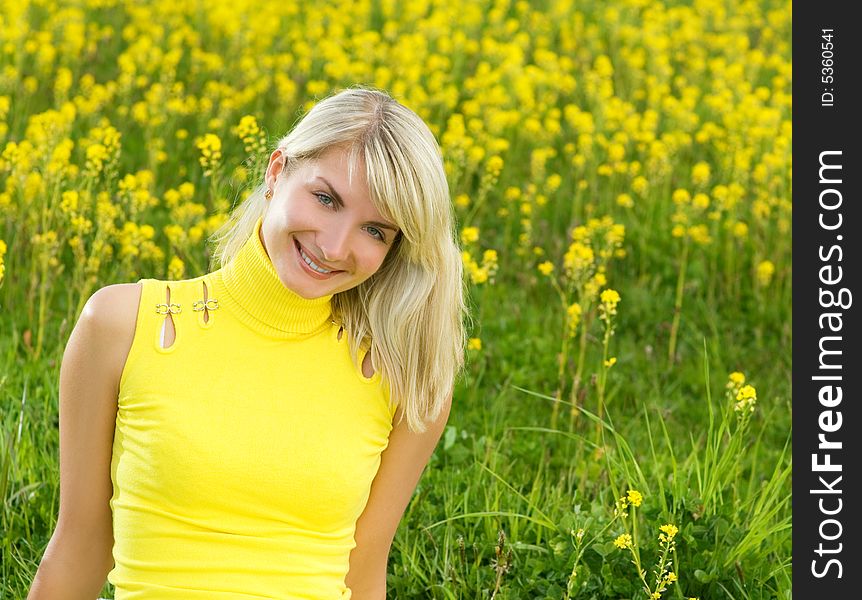 Beautiful young woman in a flower field