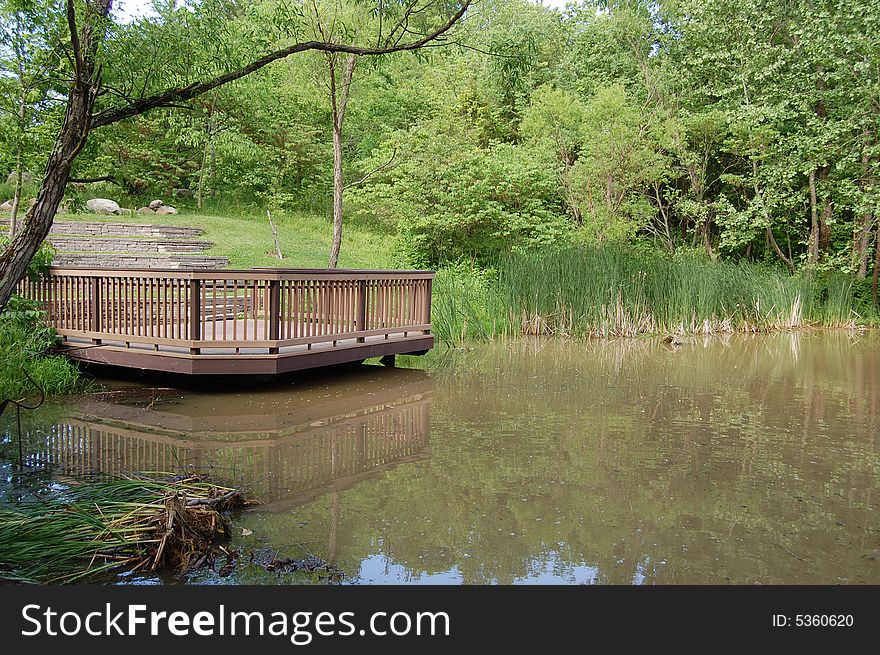 This is a deck on a lake. The water for the lake is brown and murky. This is a deck on a lake. The water for the lake is brown and murky.