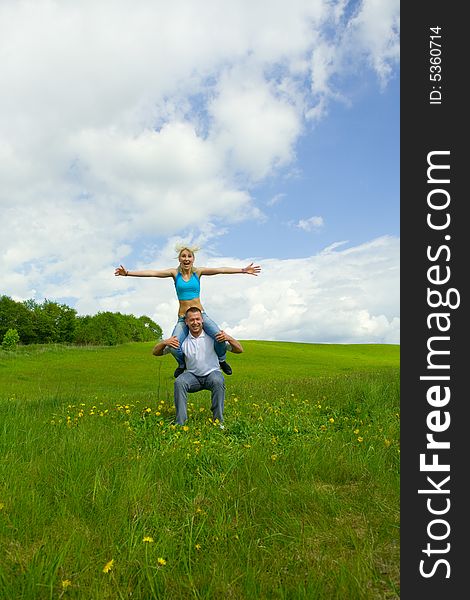 Young family jumping on a lawn