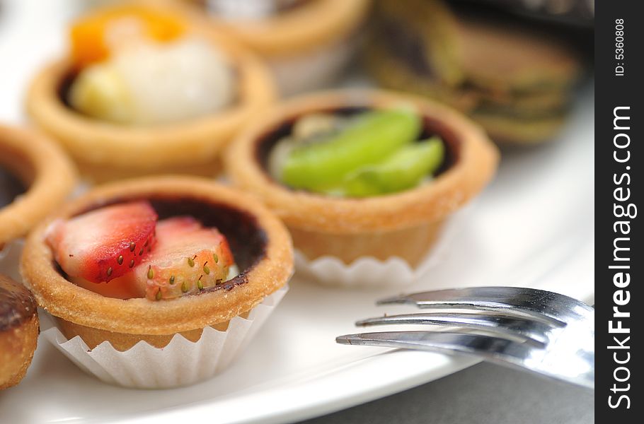 Dessert and refreshments served on a white plate. Dessert and refreshments served on a white plate