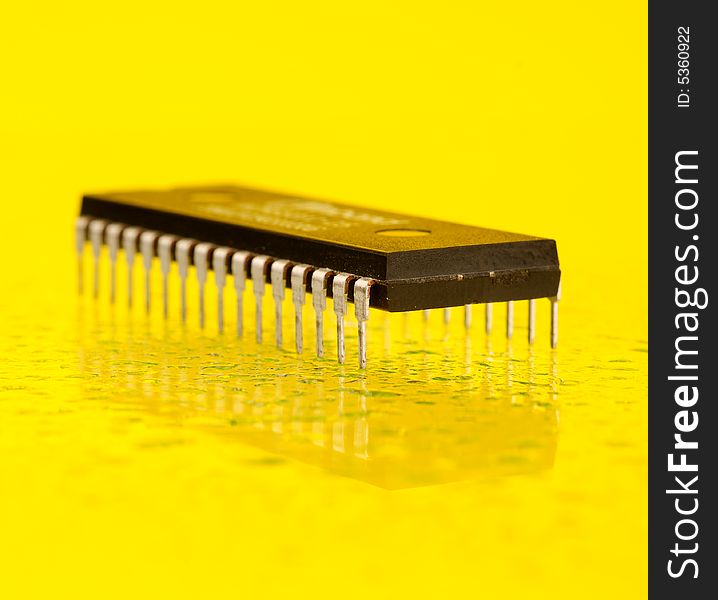 An electronic microprocessor, isolated on a yellow background.