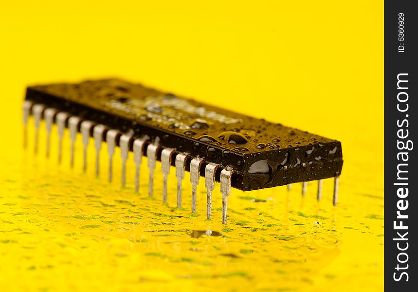 An electronic microprocessor, isolated on a yellow background.