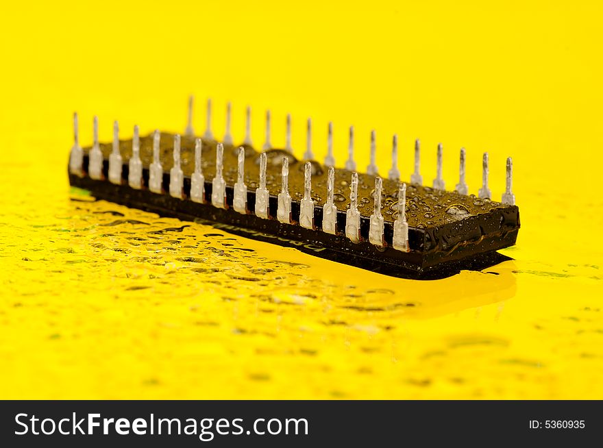 An electronic microprocessor, isolated on a yellow background.